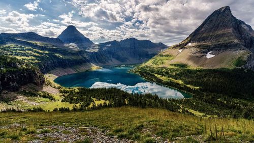 Scenic view of lake and mountains against sky