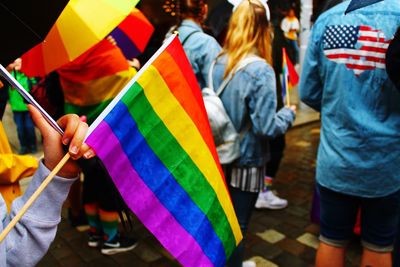 People holding multi colored umbrella