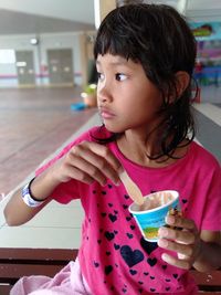 Close-up of girl having ice cream indoors