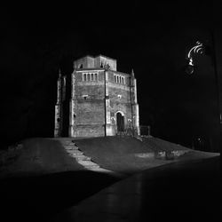 Illuminated building against sky at night