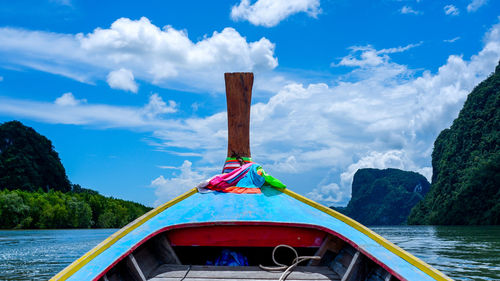 Scenic view of river and mountains against blue sky