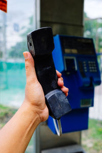 Close-up of human hand holding telephone receiver