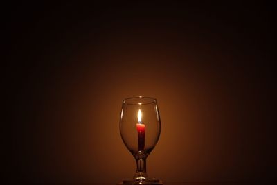 Close-up of illuminated lamp against black background