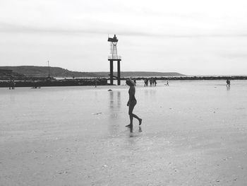 Woman walking on sand at beach