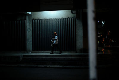 Full length of man walking on road at night