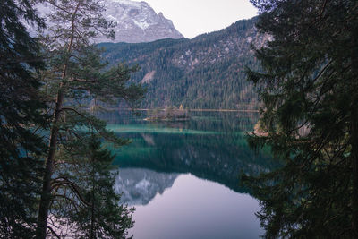 Reflection of trees in lake against sky