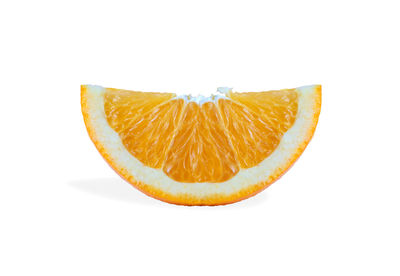 Close-up of orange slice against white background