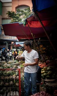 Full length of man for sale at market stall