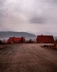 Built structure on road against sky