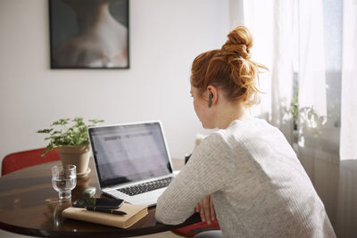 Woman using laptop at home