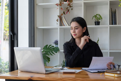 Businesswoman working at desk in office