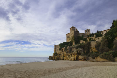 Scenic view of beach by sea against sky