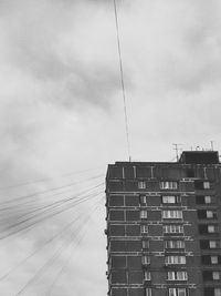 Low angle view of building against cloudy sky