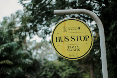 Close-up of road sign against trees