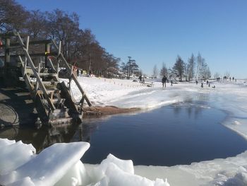 Scenic view of frozen lake against sky during winter