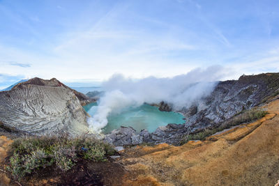 Smoke emitting from volcanic mountain against sky