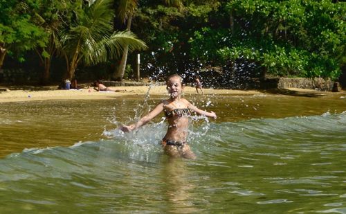 Full length of shirtless man in water