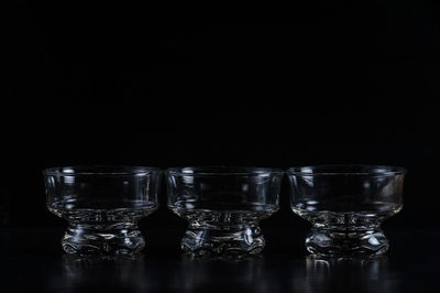 Close-up of glass bowls against black background