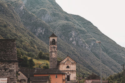 Historic building by mountains against sky