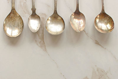 Directly above shot of silver spoons on table