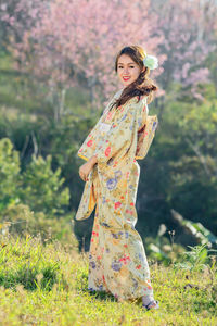 Portrait of woman standing against plants