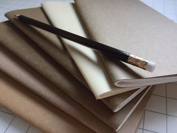 High angle view of pencil and books on table