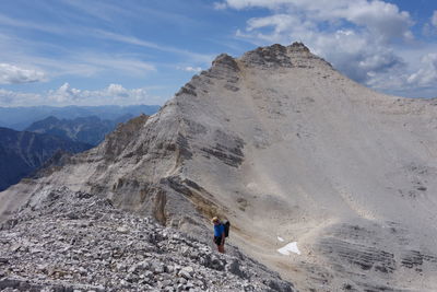 High angle view of person climbing on mountain against cloudy sky at karwendel