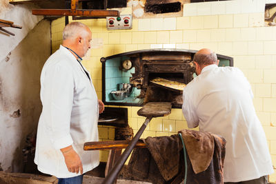 Rear view of man working in workshop