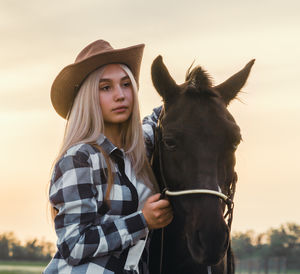 Portrait of young woman with horse