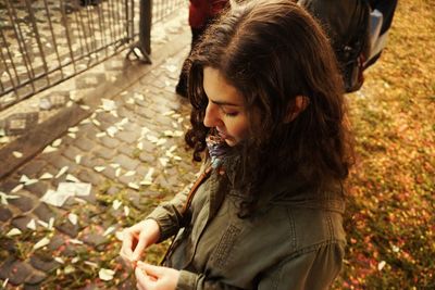Young woman standing on footpath