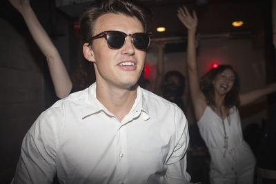 Portrait of smiling young man wearing sunglasses