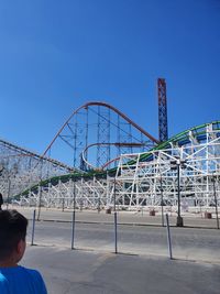 View of ferris wheel against blue sky