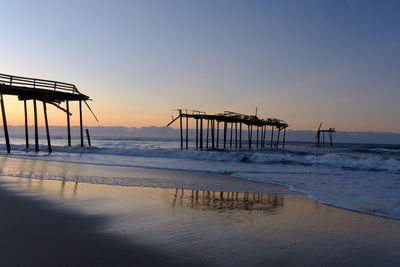 Scenic view of sea against clear sky at sunset