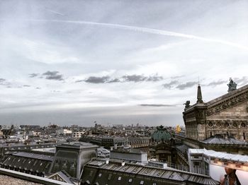 View of city against cloudy sky