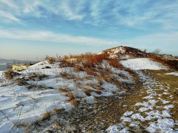 Snow covered field against sky