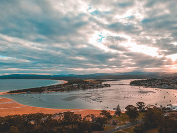 Scenic view of beach against sky during sunset