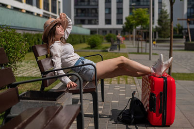 Woman sitting on bench in park