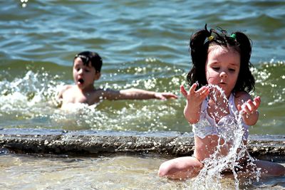 Happy girl splashing water