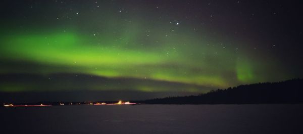 Scenic view of lake against sky at night