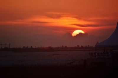 Scenic view of silhouette trees against orange sky