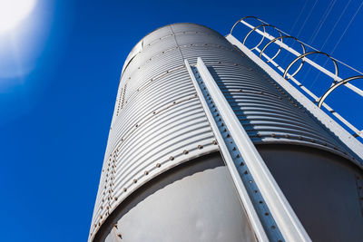 Low angle view of modern building against clear blue sky