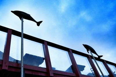 Low angle view of seagull perching on railing