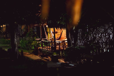 View of illuminated table against trees at night