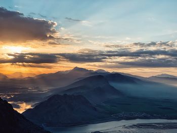 Scenic view of snowcapped mountains against sky during sunset