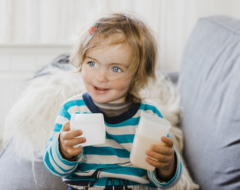 Cute girl playing with cups at home