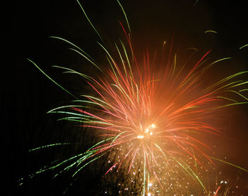 Low angle view of firework display at night