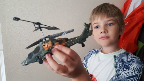 Boy playing with toy helicopter