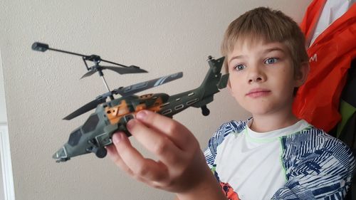 Portrait of boy holding camera