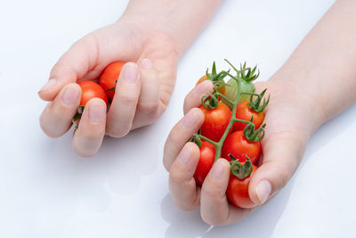 Close-up of hand holding strawberry