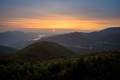 Scenic view of mountains against sky during sunset
